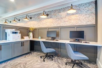 a home office with two desks and two computer monitors